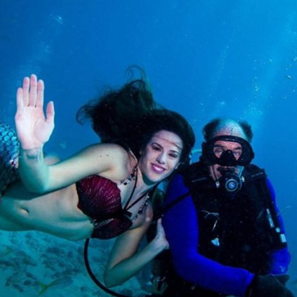 Mermaid saying hello to scuba diver in the florida keys