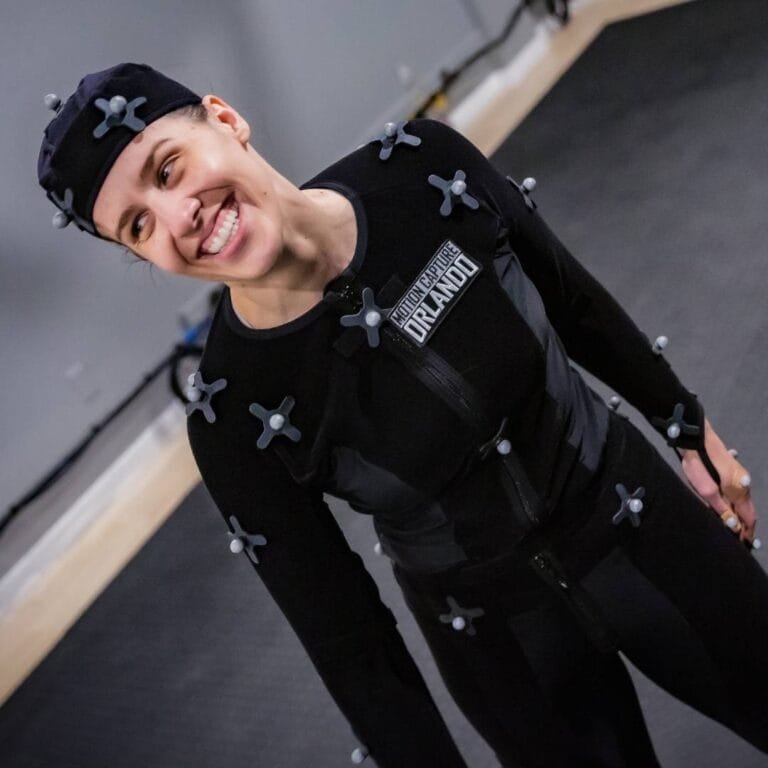 Motion capture actor Shannon Scott performing in a volumetric capture stage wearing a mocap suit with tracking markers.