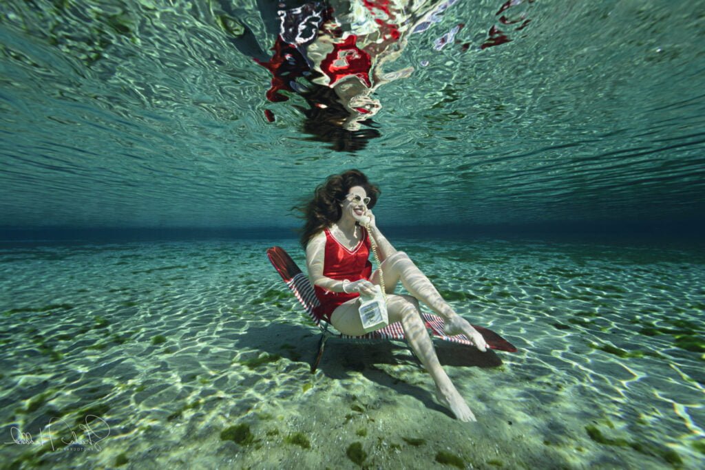 Shannon Scott contact photo – professional female voice actor talking on the phone underwater