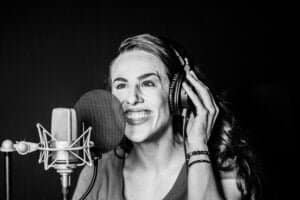 Shannon Scott smiling near microphone – studio specs overview
