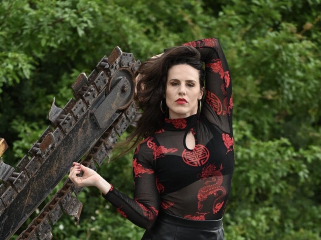 Freelance Model Contracts: How to Protect Yourself, Your Image & Your Work 3 Freelance model posing in red and black outfit with greenery