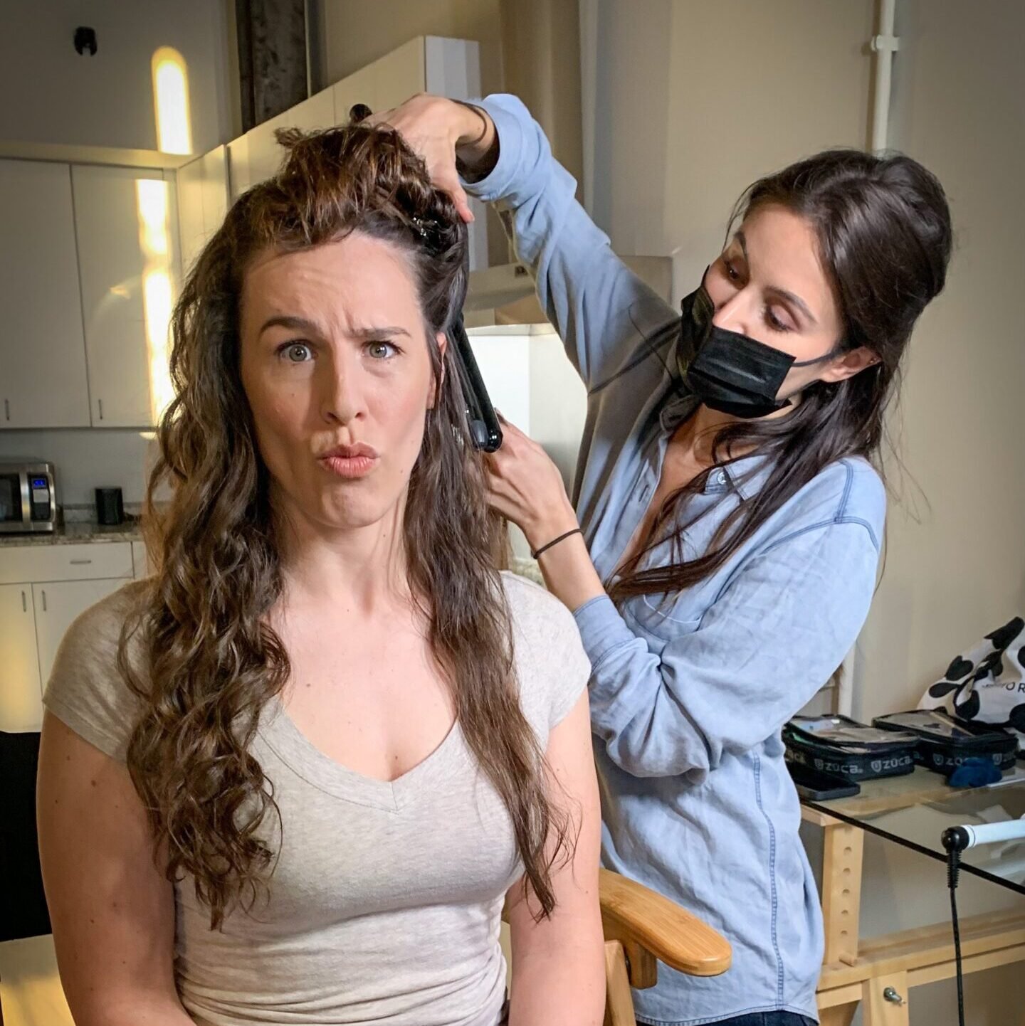 Shannon Scott makes a funny face at the camera while getting her hair curled, capturing the humor and resilience behind dealing with audition rejection in the acting world.