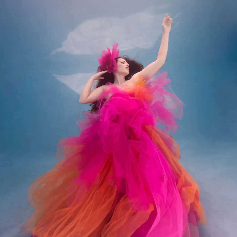 Shannon Scott underwater modeling for film and fashion, showcasing elegant movement and breath control in a cinematic, bright fashion setting.