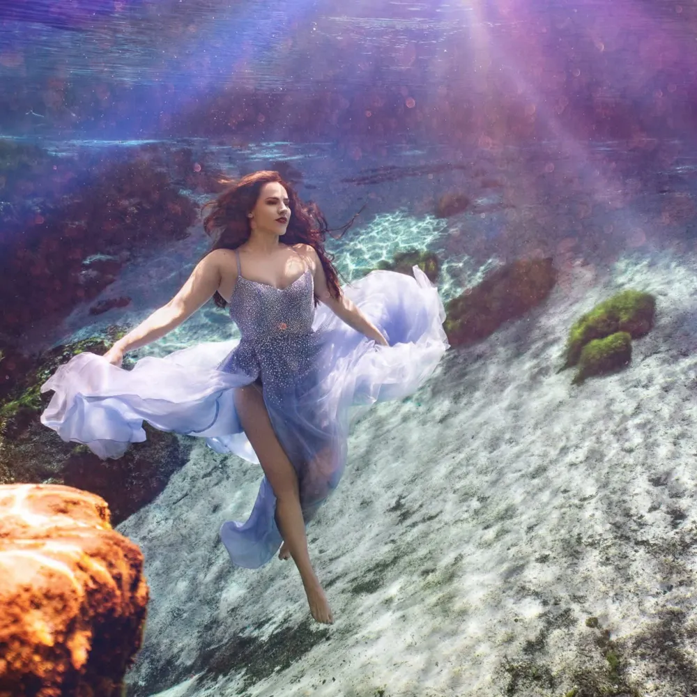 The Magic of Becoming: What Halloween Teaches Performers About Transformation 4 Freediver model Shannon Scott gliding effortlessly underwater, demonstrating breath-hold control, strength, and grace beneath the surface.