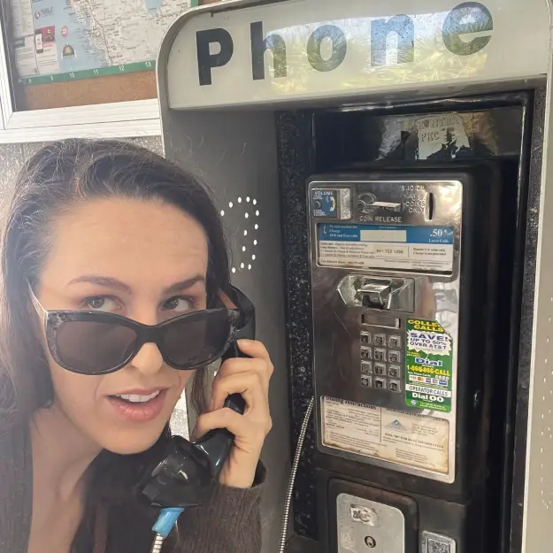 The Bright Stars Greenroom 1 Voiceover artist Shannon Scott on a retro pay phone, symbolizing her versatile voiceover style and character range