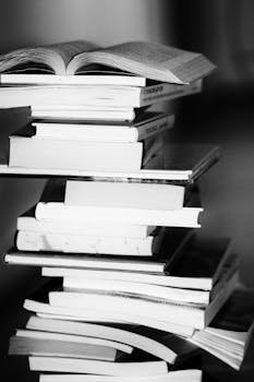 6 Reasons Why Hiring a Professional Voiceover Artist Is a Smart Investment for Your Brand (Yes, Even In The Age of AI...) 7 A monochrome image of a tall stack of books symbolizing education and knowledge.