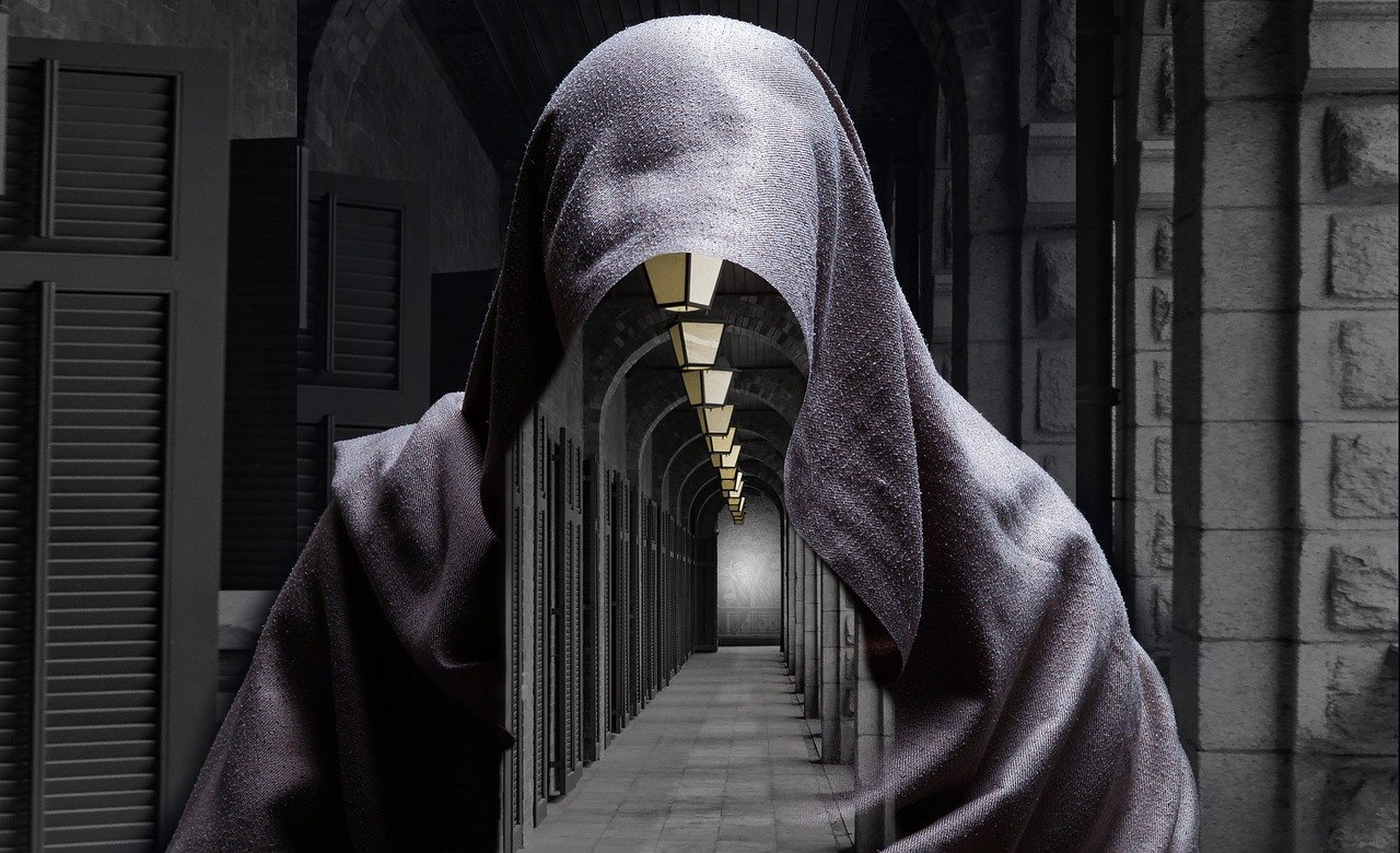 A mysterious figure in a cloak appears invisible, revealing a hallway through their body, symbolizing the unseen inner journey and an open acting mindset of the unseen.