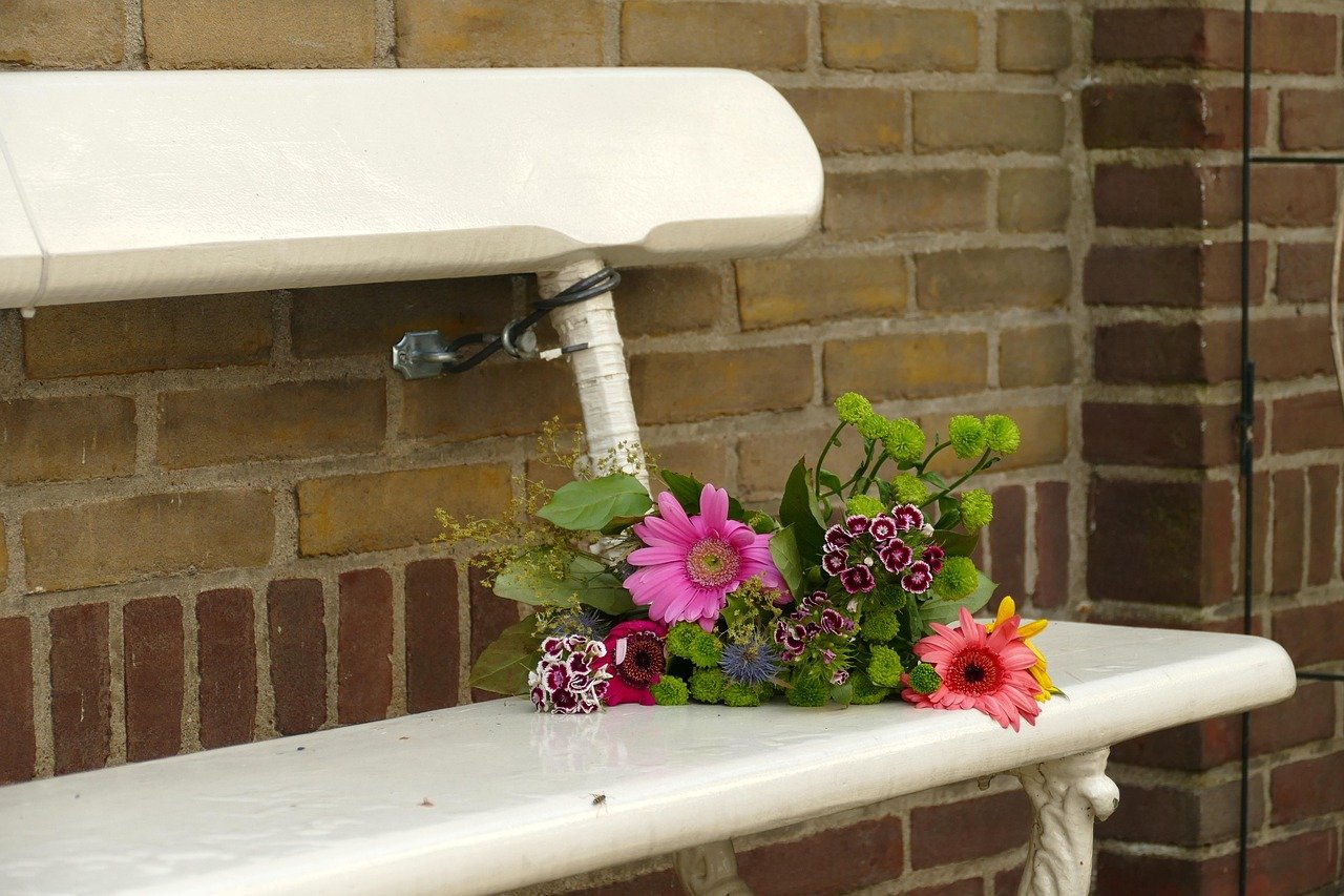 bench with flowers, honoring the memory of Ozzy Osbourne