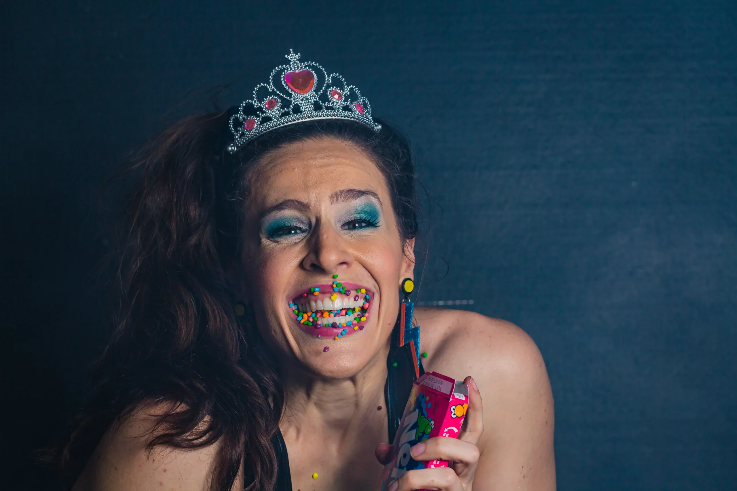 3 Fall Self-Care Rituals for Creatives (and Why We All Need a Little Magic Right Now) 5 Shannon Scott wearing a tiara with candy Nerds as lipstick, radiating bubbly and quirky energy.