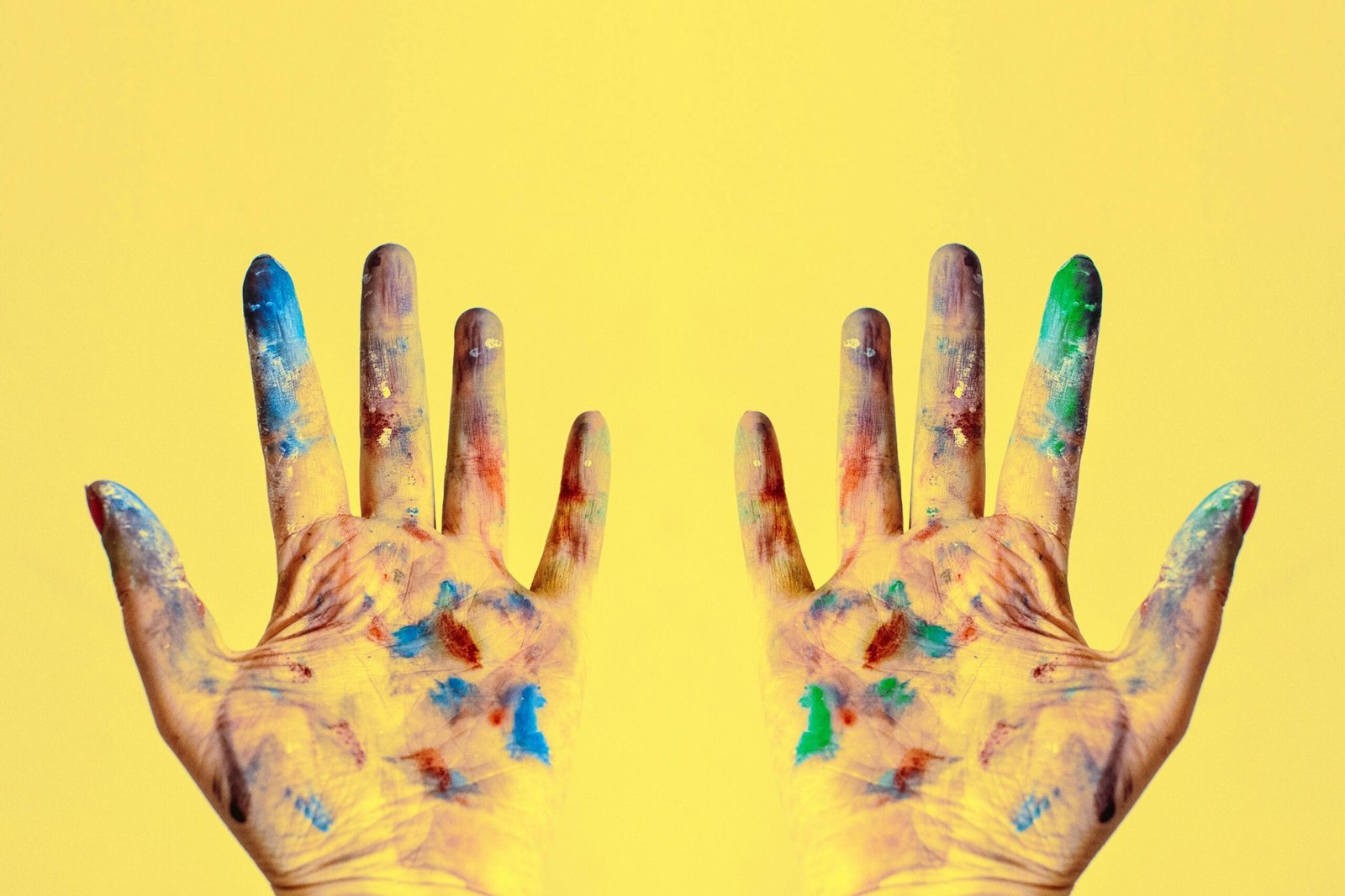 The Rise of AI in Acting: A Wake-Up Call for Human Creators 3 A close-up of a hand covered in vibrant paint with the words “human creativity” written across the palms