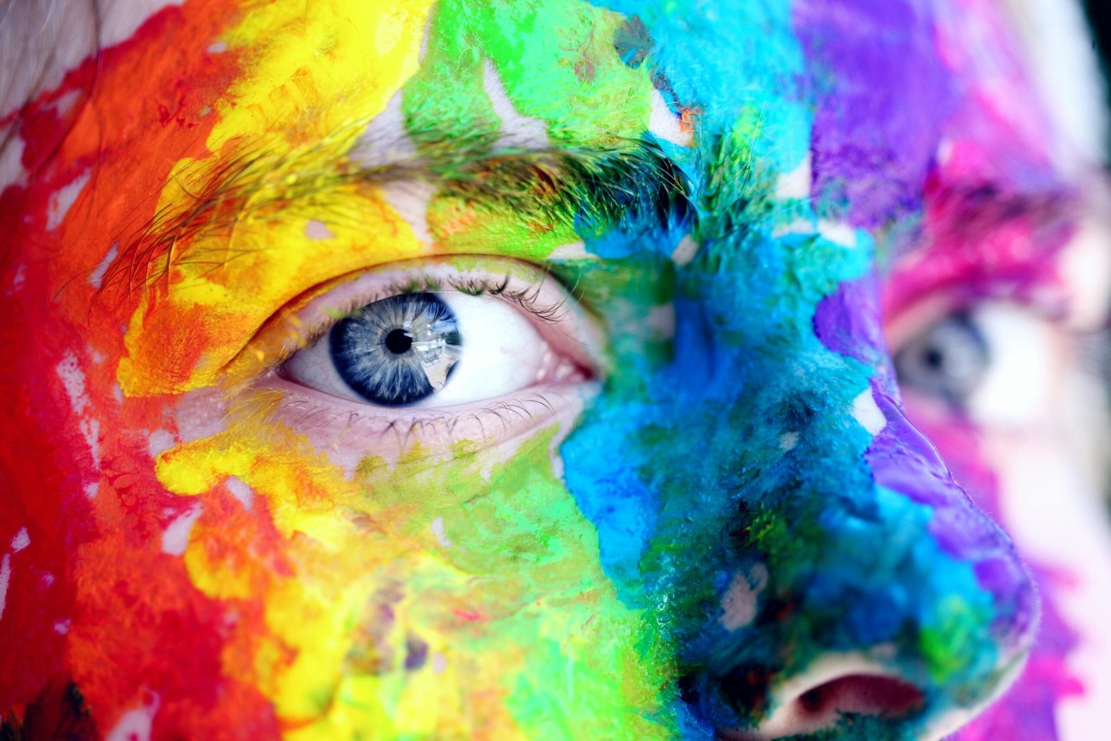 Beyond the Algorithm: Why Replacing Real Performers with AI Will Cost You More Than Money 5 Close-up of a person with colorful rainbow face paint, symbolizing LGBT pride and expression.