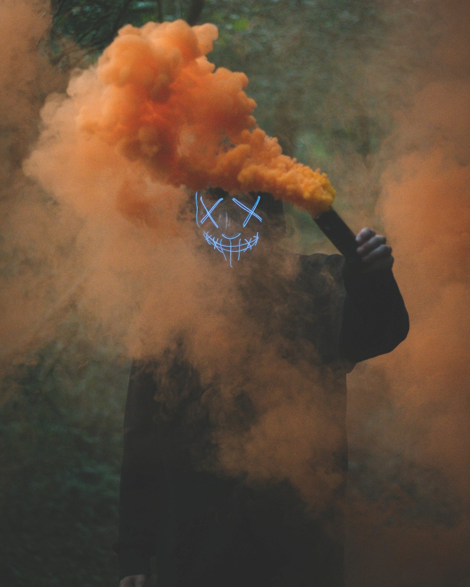 Beyond the Algorithm: Why Replacing Real Performers with AI Will Cost You More Than Money 2 Person with mask and smoke bomb symbolizing the Impact of AI on creative industry