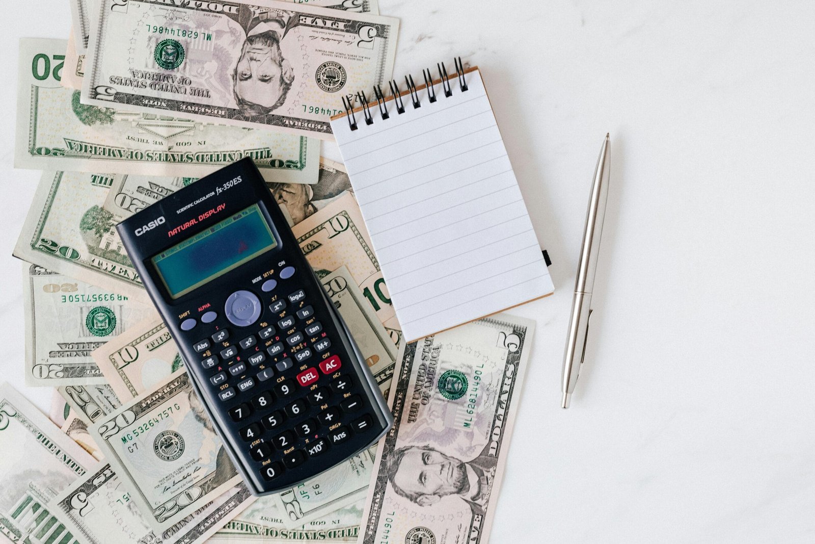 The Pay‑to‑Play Hustle: What It Really Costs to Be a Working Actor 2 Calculator and cash representing typical actor expenses and the cost of pursuing a performing career.