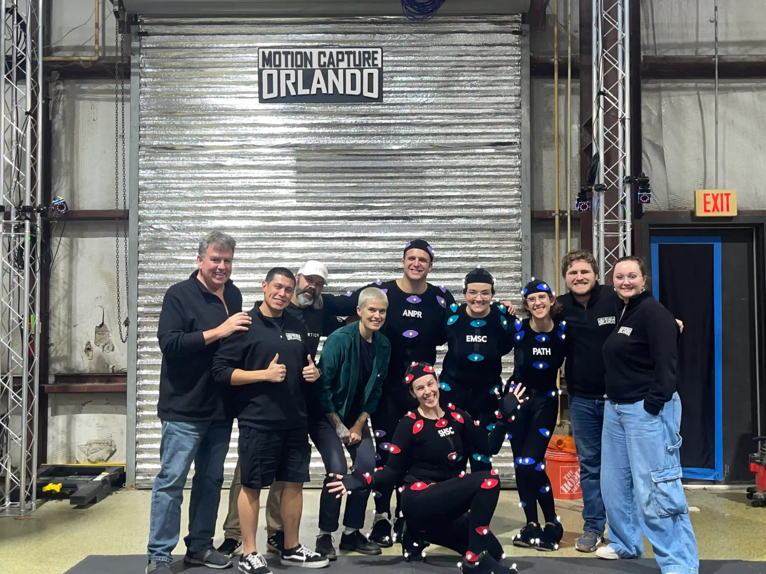 Motion Capture Lessons Learned From a Performer in the Volume 1 Group of performers and tech team smiling on set after a motion capture session, celebrating successful collaboration.