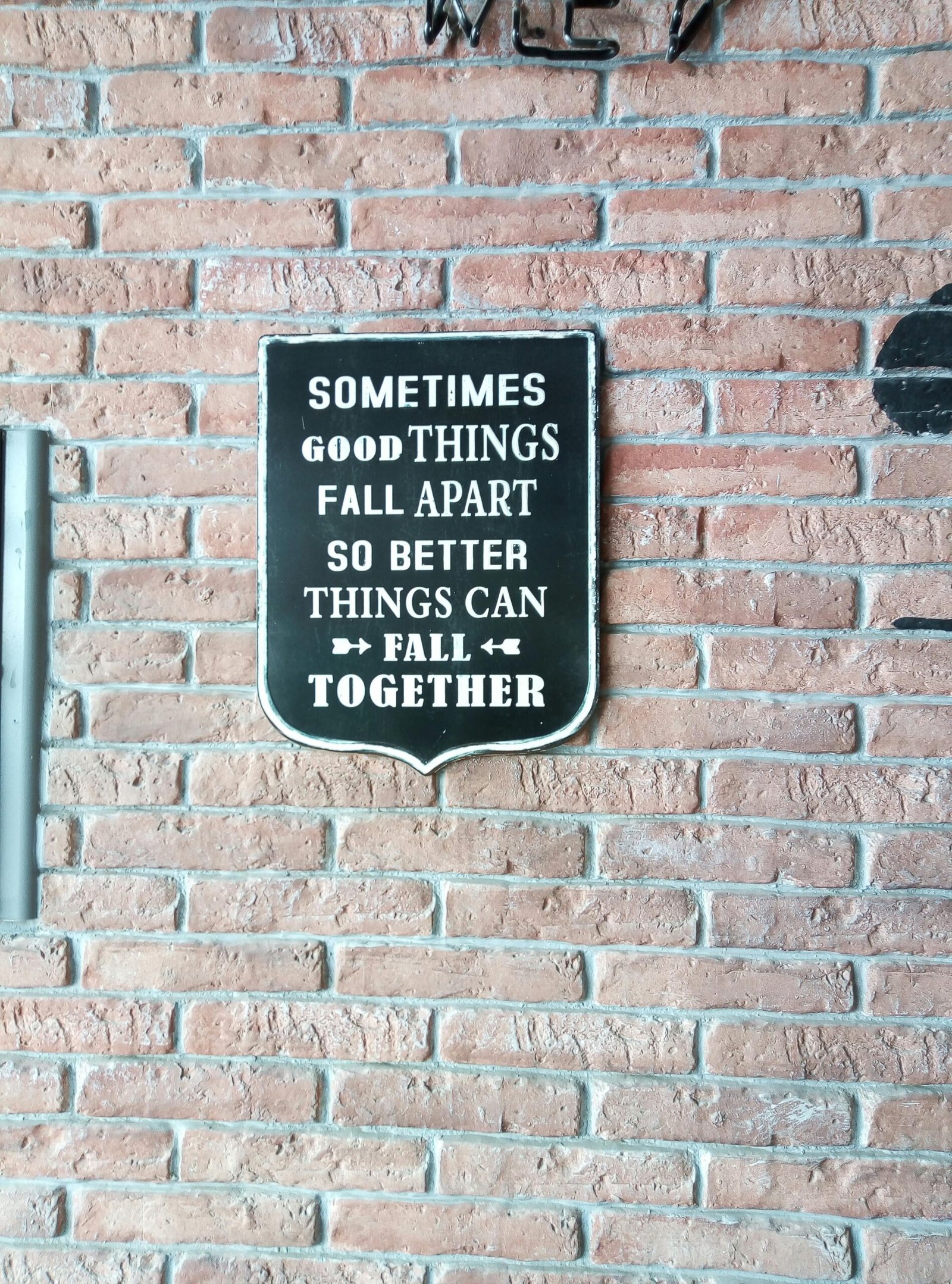 A sign with an inspiring message about things falling apart so they can fall better, representing creative clarity and growth through change.
