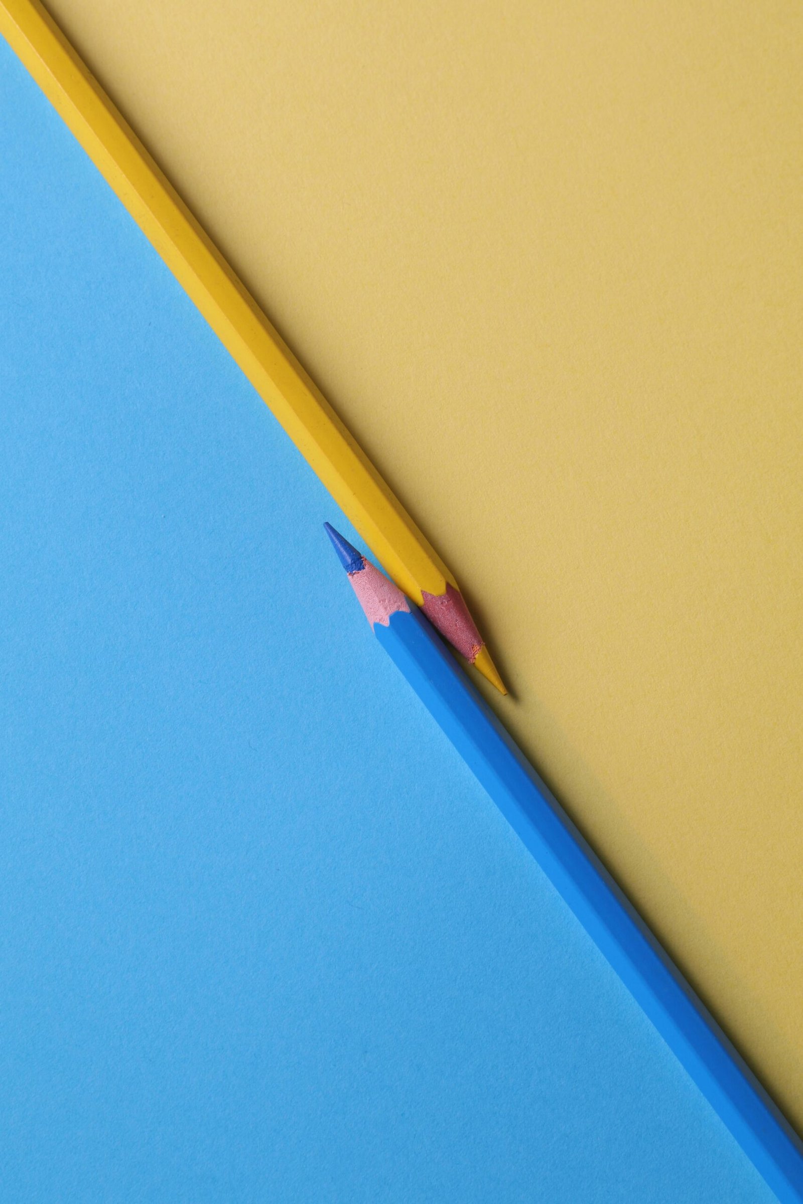 How to Choose the Right Voiceover for Your Brand (And Why It Matters More Than You Think) 4 Two colored pencils placed on a matching colored background, symbolizing the tone of the human voice.