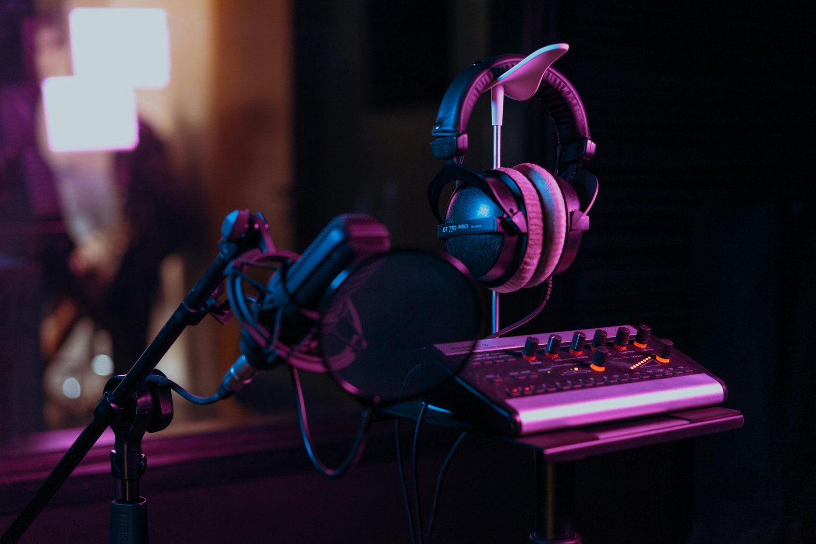 How to Choose the Right Voiceover for Your Brand (And Why It Matters More Than You Think) 6 Studio microphone and over-ear headphones in a recording booth, representing voiceover production.
