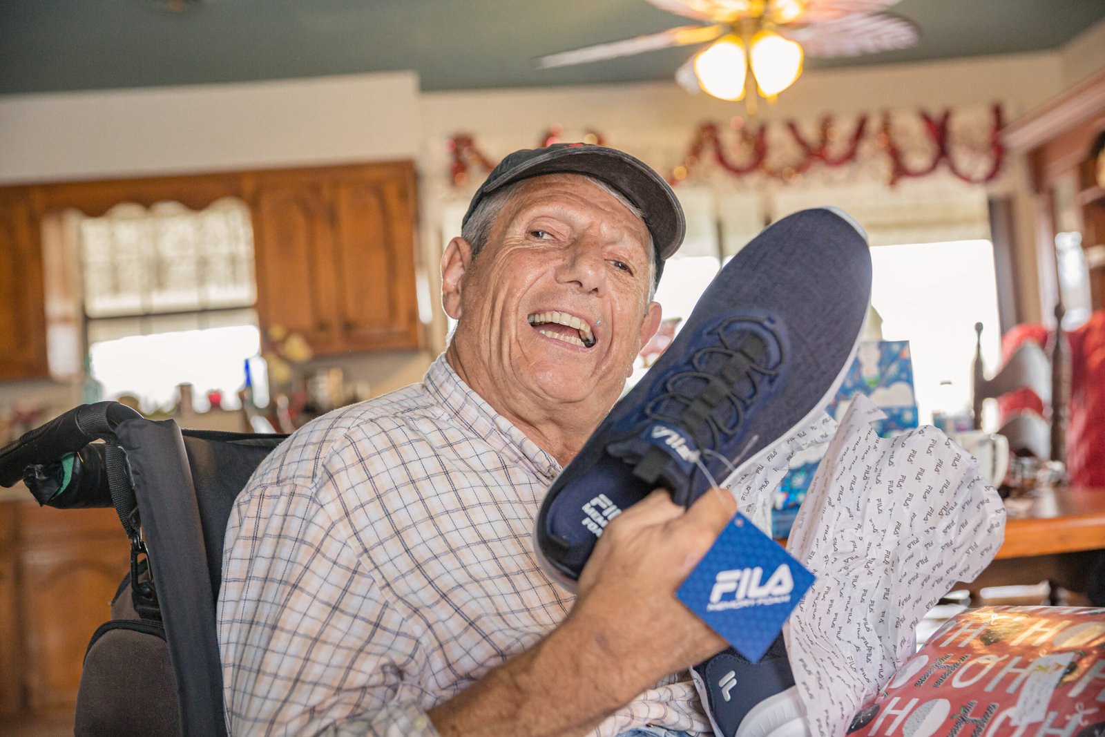 Joe Scott smiling and holding a new pair of shoes during the Eddie’s Trailer Park production.