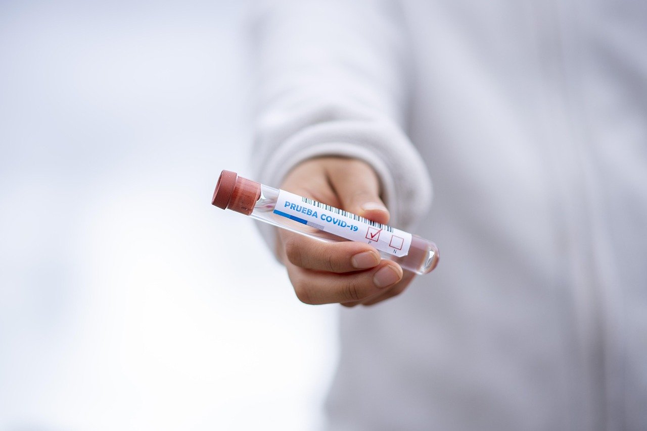 Doctor holding a test tube in a clinical setting representing medical eLearning voiceover content