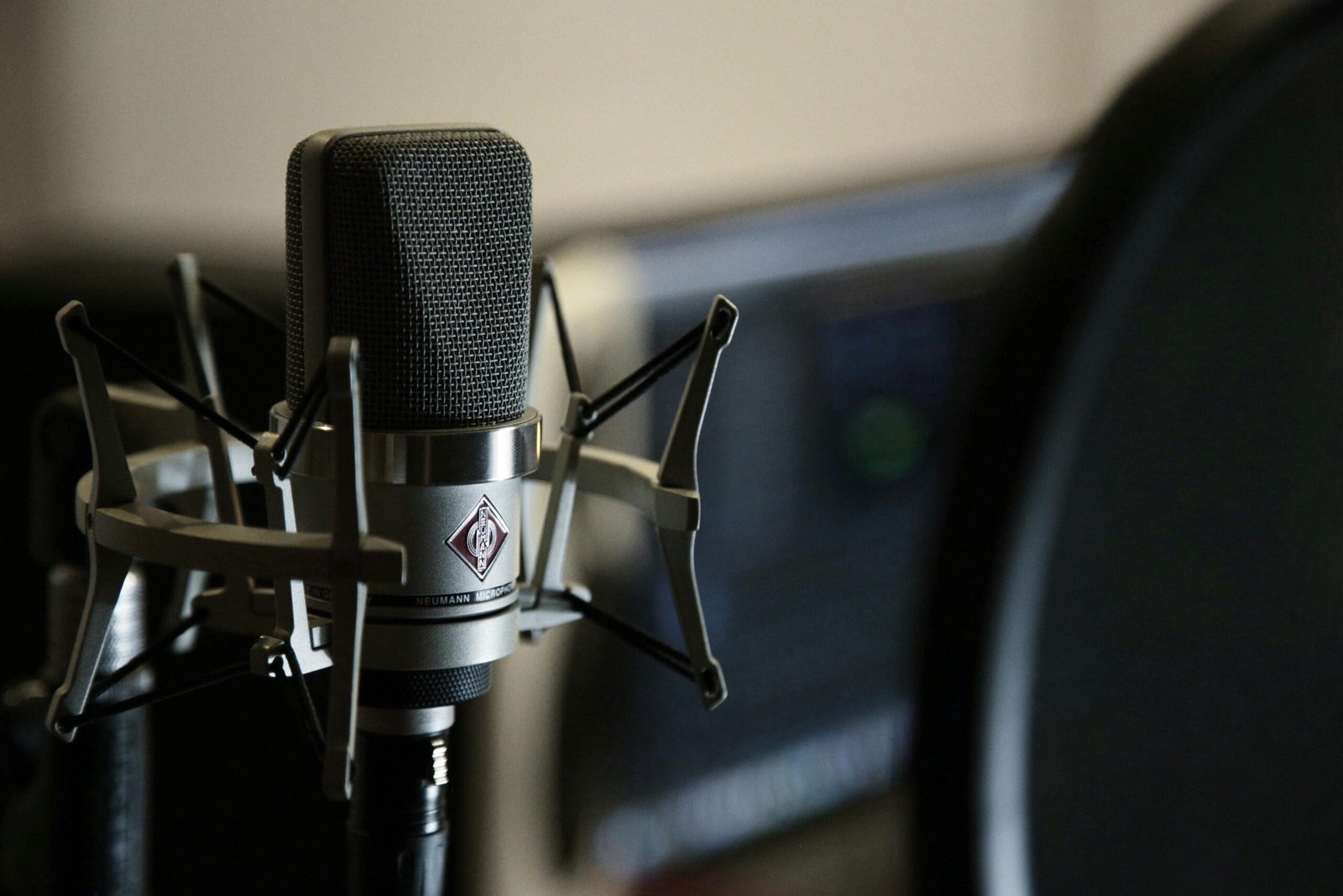 Voice actor business tips concept shown through a professional voice over studio microphone setup with a Neumann TLM 103 on a desk