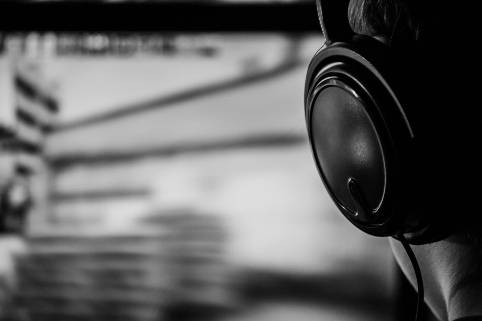 How to Hire the Right Female Voice Actor for Your Brand 3 Black and white image of a person listening to audio with headphones highlighting professional voice over services