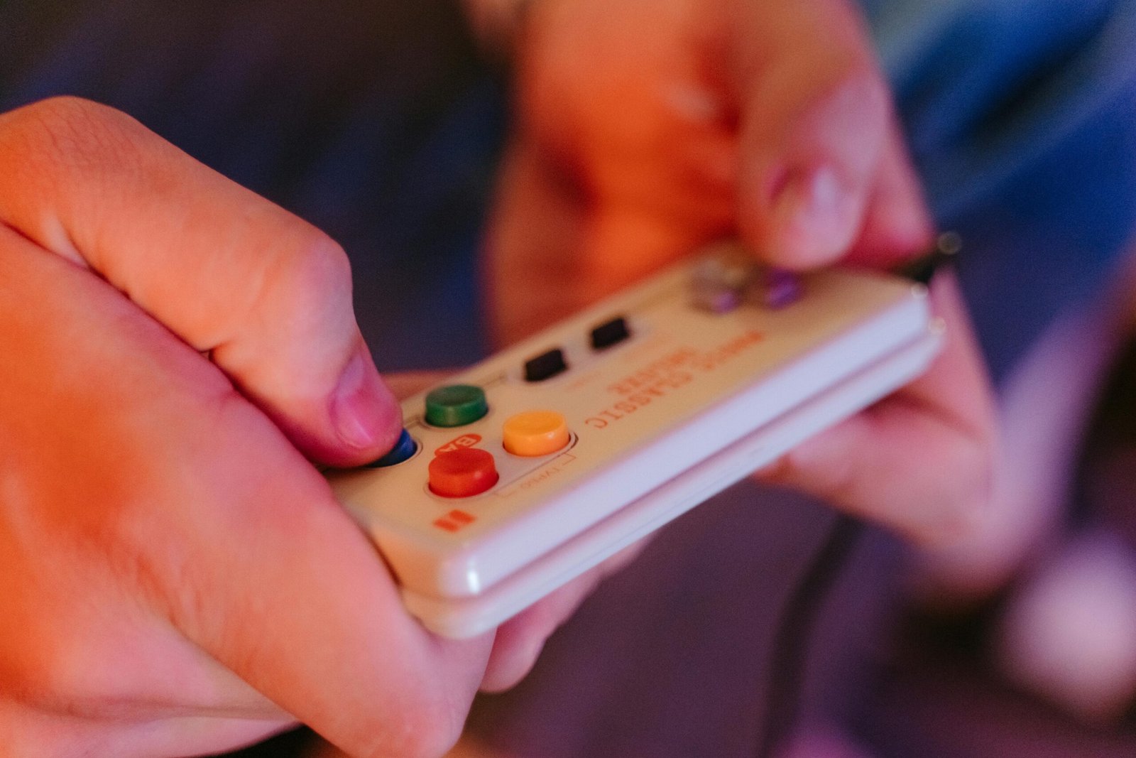 Hands holding a retro video game controller representing voice over demos for video game and character narration