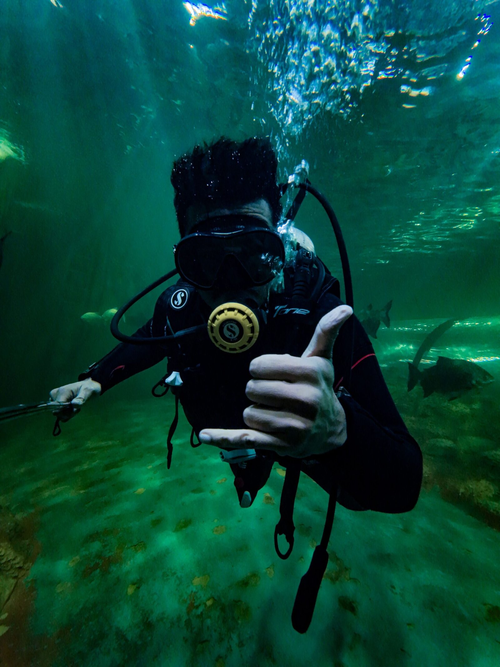 Underwater Film Production: What Producers Need to Know Before Production 3 Scuba diver underwater in Kerala, India, signaling hang loose. Vibrant marine scenery.