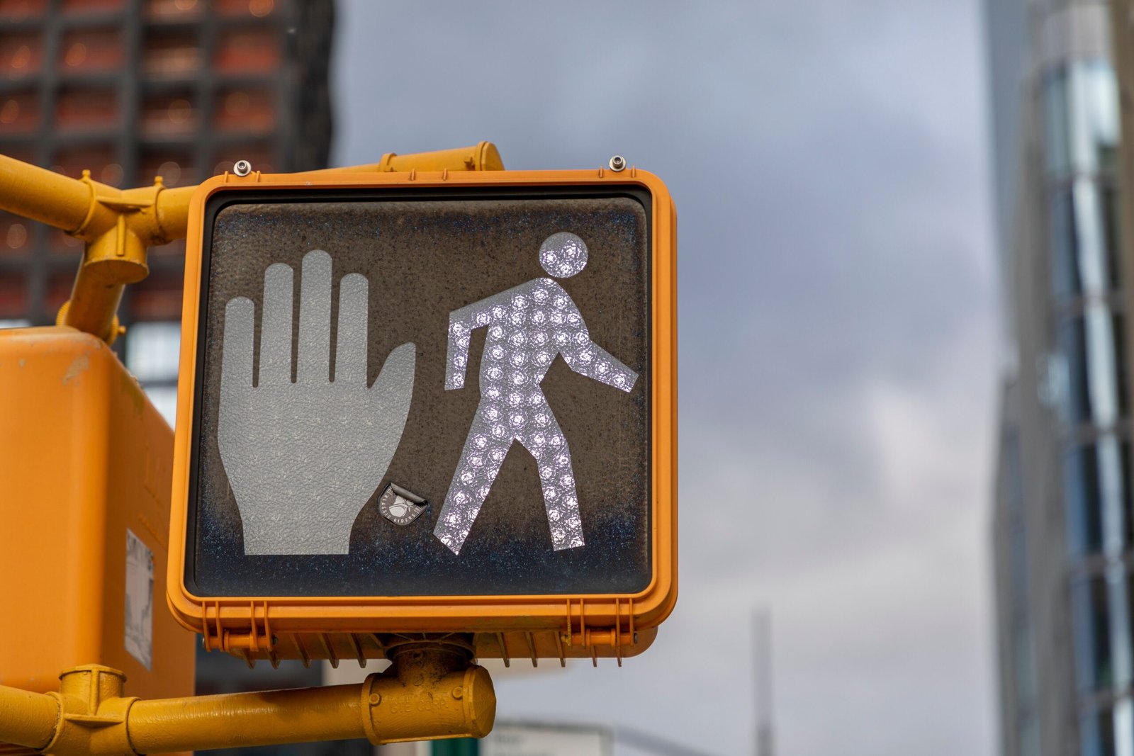A pedestrian walk signal illuminated against the sky, symbolizing the visual identity of professionalism and readiness in a voice actor's career.