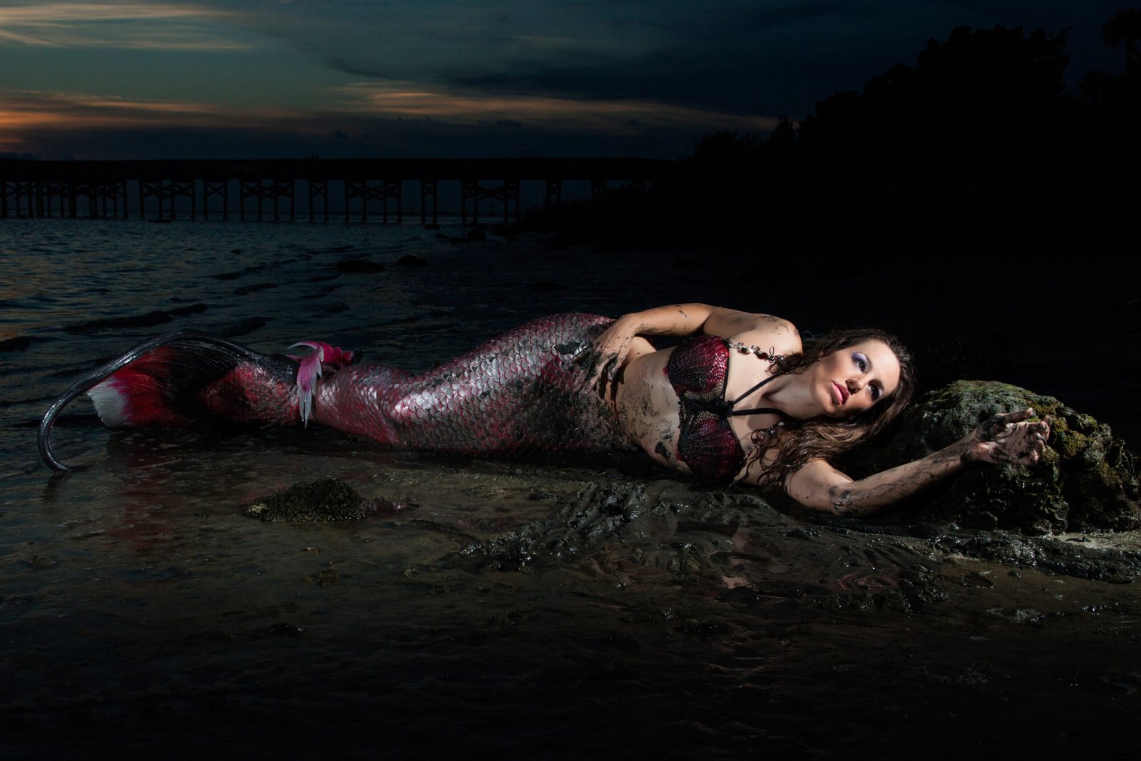 Shannon Scott performing as a mermaid on the beach at night, showcasing her range beyond voiceover