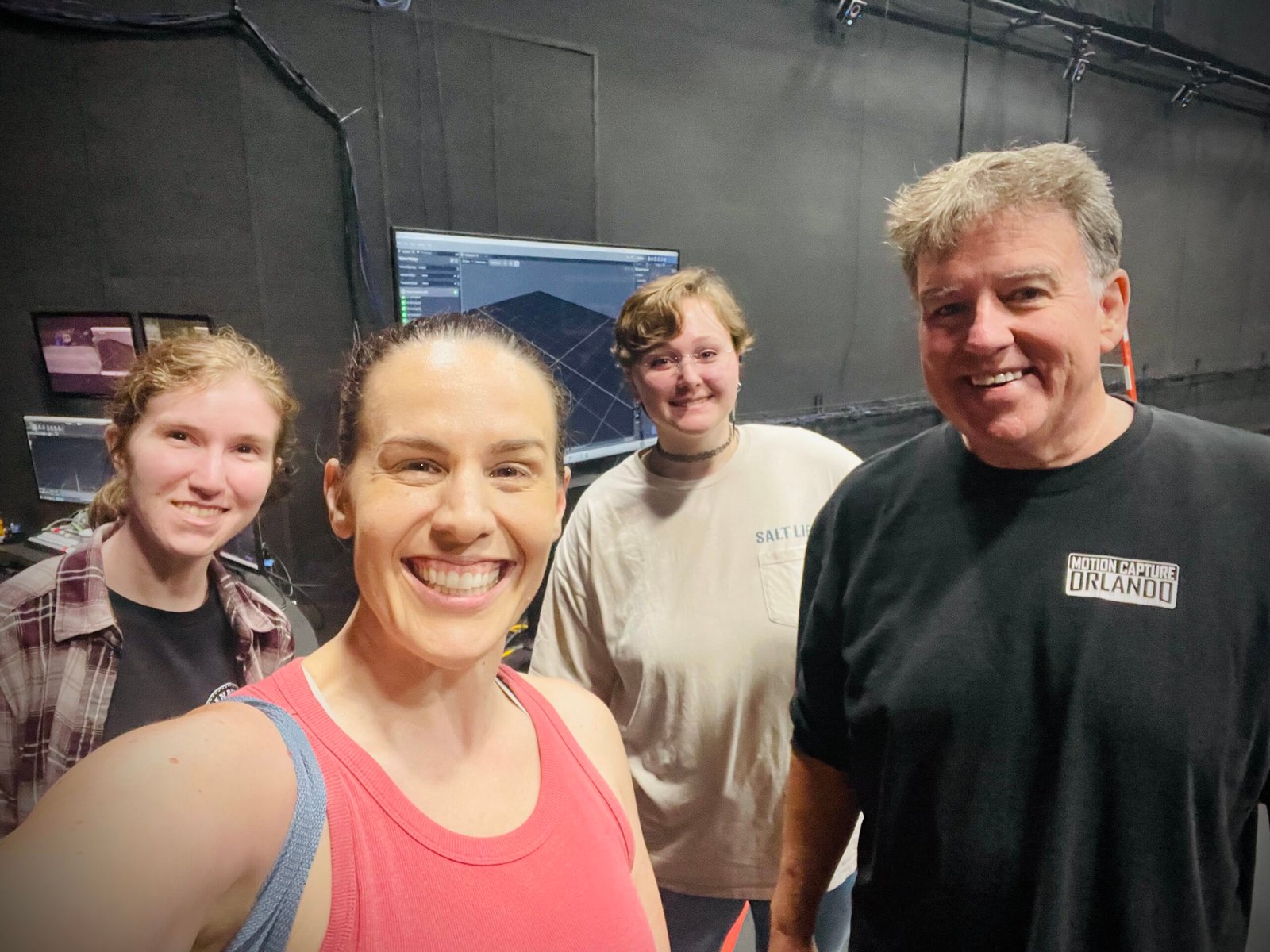 Stepping Onto the Mocap Stage: What It's Really Like to Work as a Motion Capture Actress 4 Shannon Scott and the motion capture team smile together in a group photo after wrapping a successful day of motion capture work.
